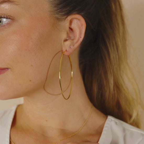 Woman Wearing Infinity Hoops