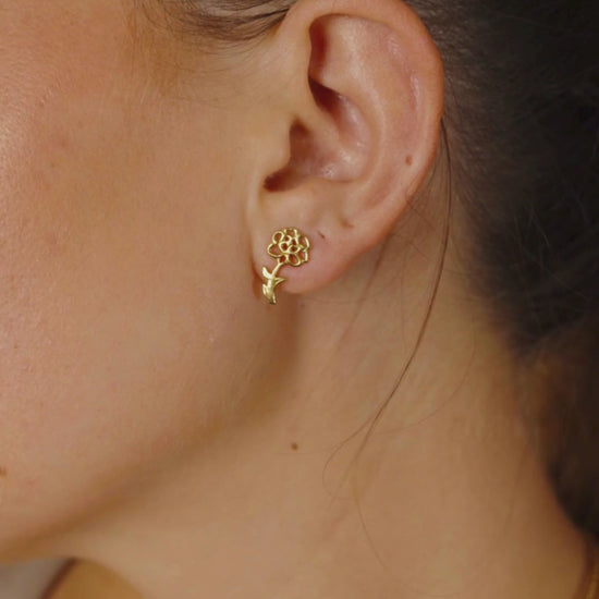 Woman Wearing Gold Birth Flower Stud Earrings