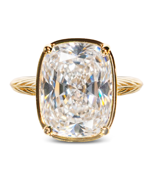 Gold ring with a large diamond on a white background
