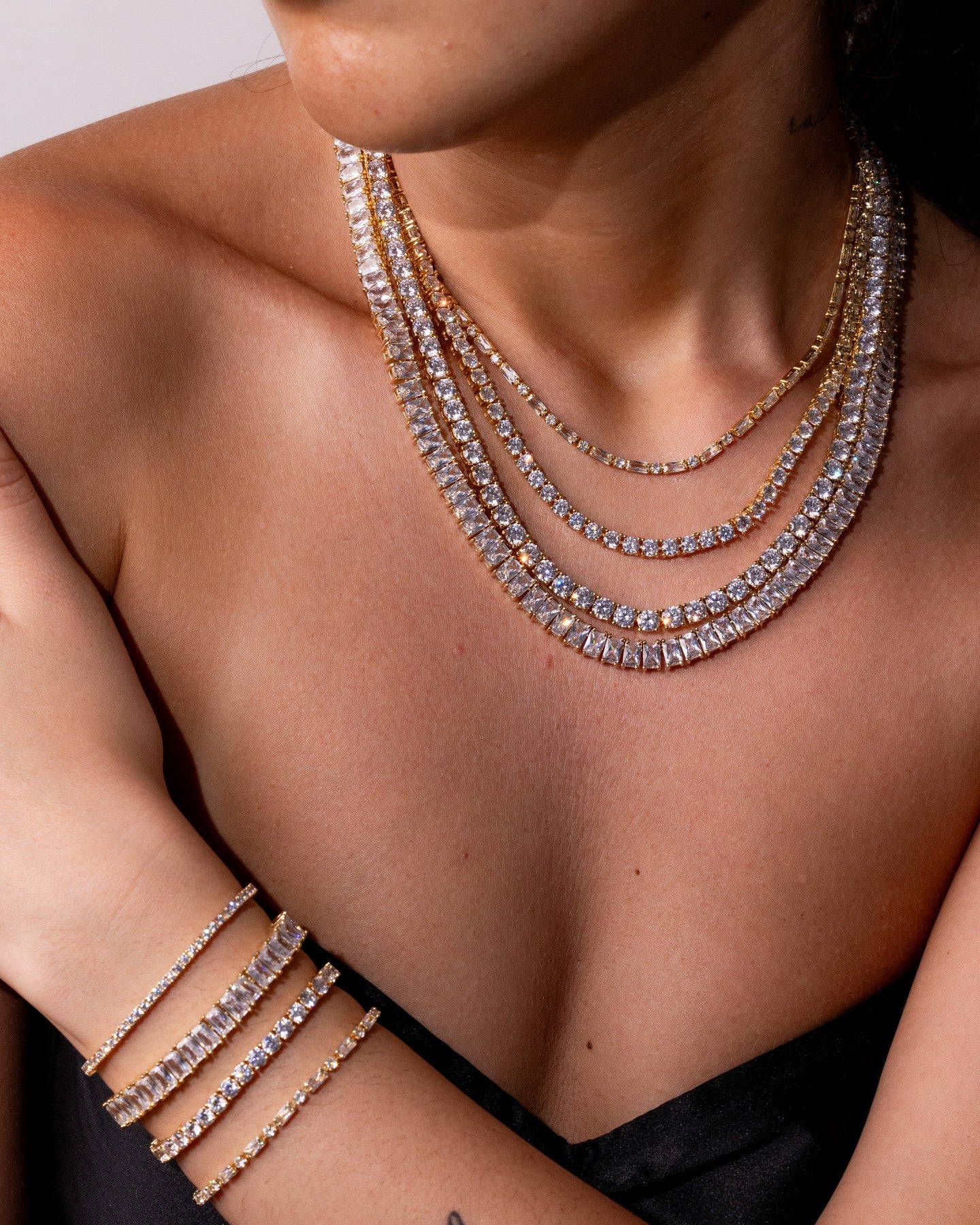 Silver tennis necklace and bracelet worn together