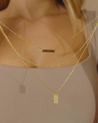 Girl Wearing Triple Layered Bar Necklace