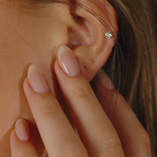 Woman Wearing Silver CZ Stud Earrings