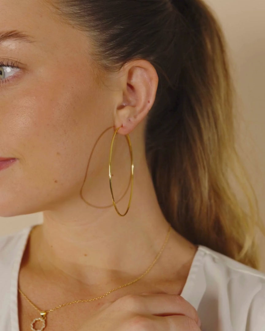 Woman Wearing Infinity Hoops